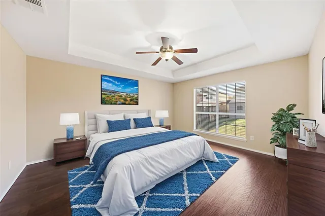 a spacious bedroom with a bed a chandelier and a window