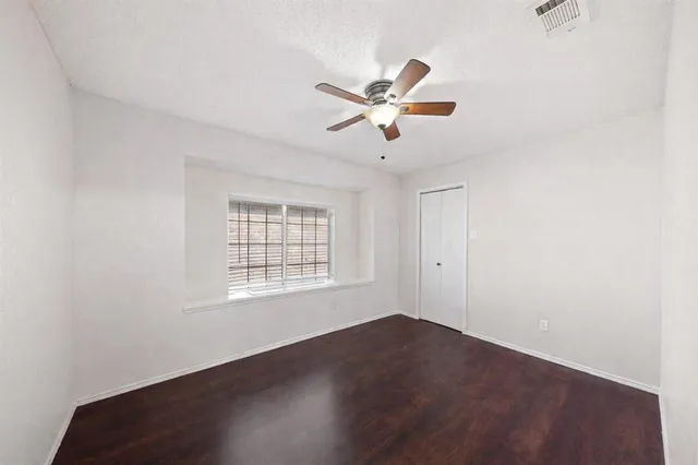 a view of a room with wooden floor and windows in it
