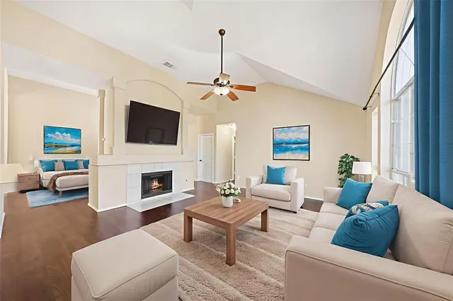 a living room with furniture a fireplace and a flat screen tv
