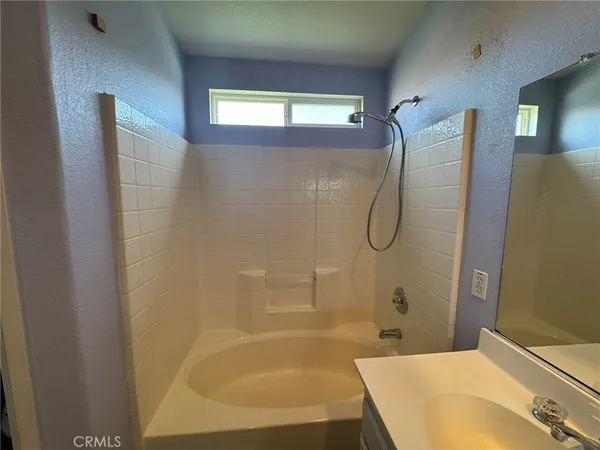a bathroom with a bathtub and a shower