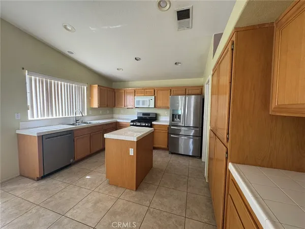 a kitchen with a sink a stove top oven and appliances