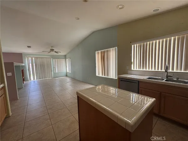 a kitchen with a sink a stove and cabinets