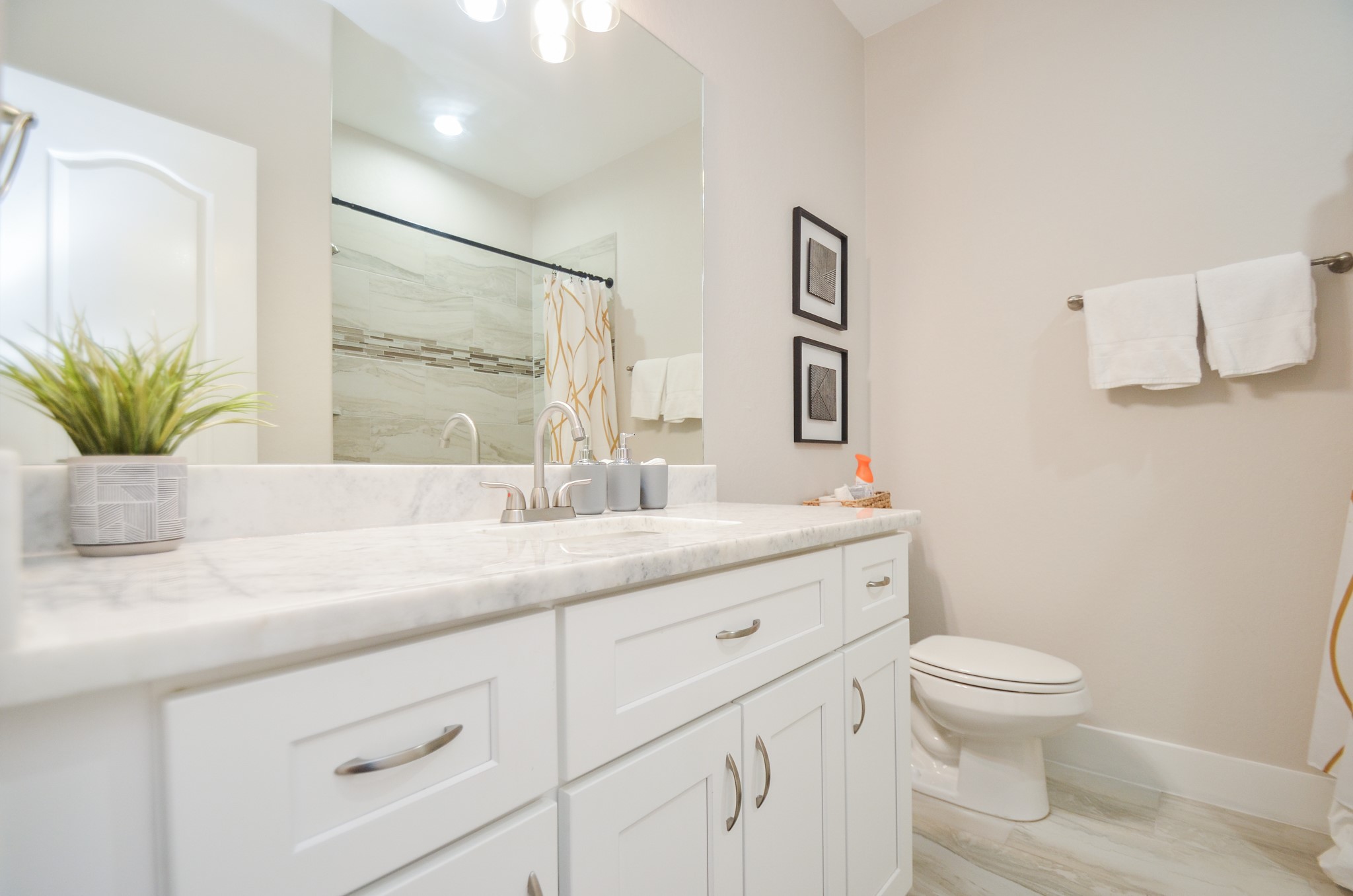 4511 Reed Road Houston, TX 77051 - Photo 32 of 39 a bathroom with a granite countertop toilet sink and mirror