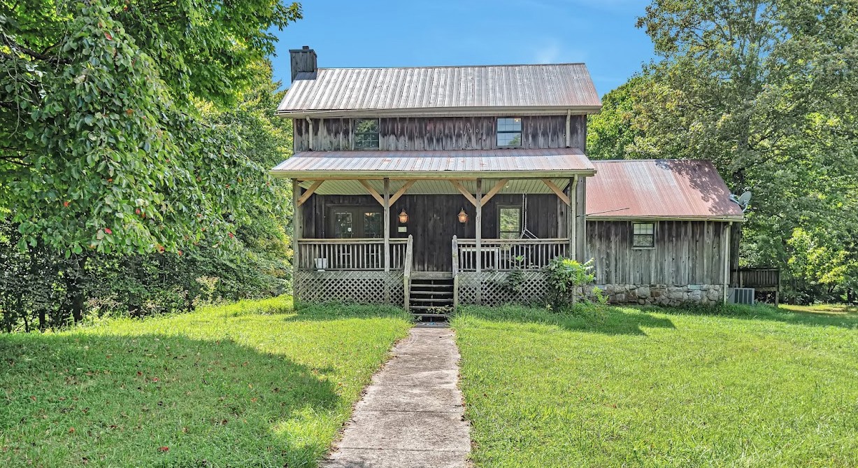 450 Womack Road Portland, TN 37148 - Photo 1 of 22 a front view of a house with garden