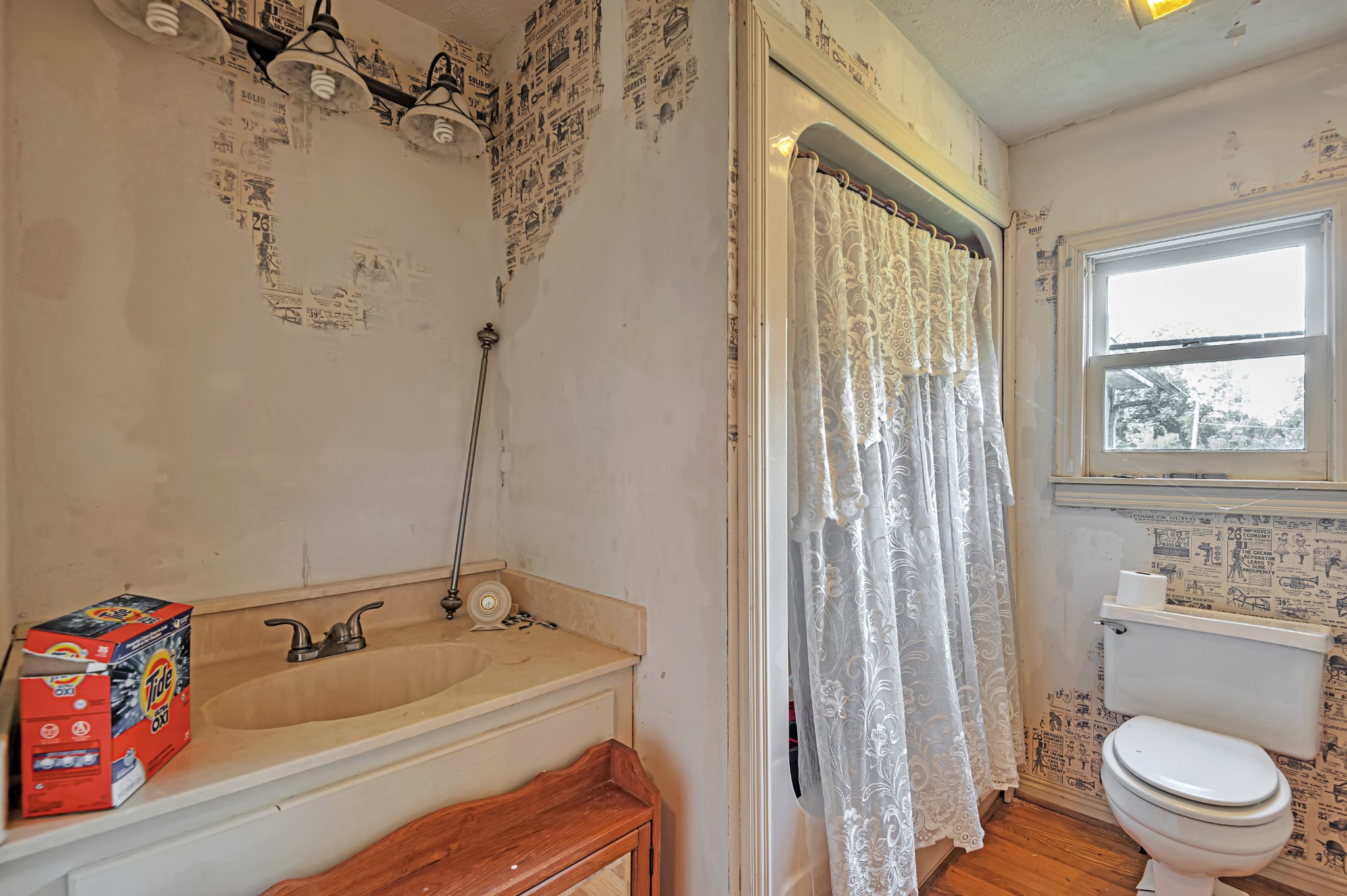 450 Womack Road Portland, TN 37148 - Photo 12 of 22 a bathroom with a sink a toilet and a shower curtain