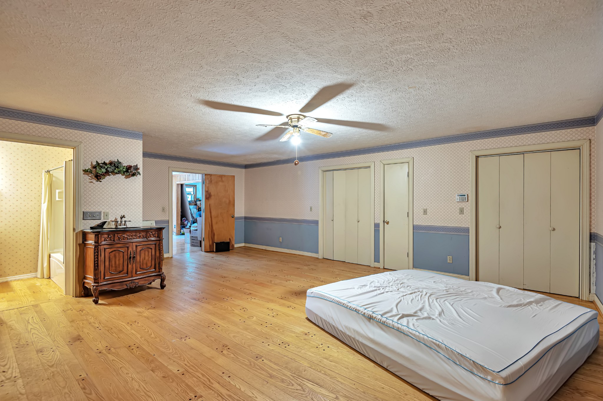450 Womack Road Portland, TN 37148 - Photo 15 of 22 a spacious bedroom with a bed and a chandelier