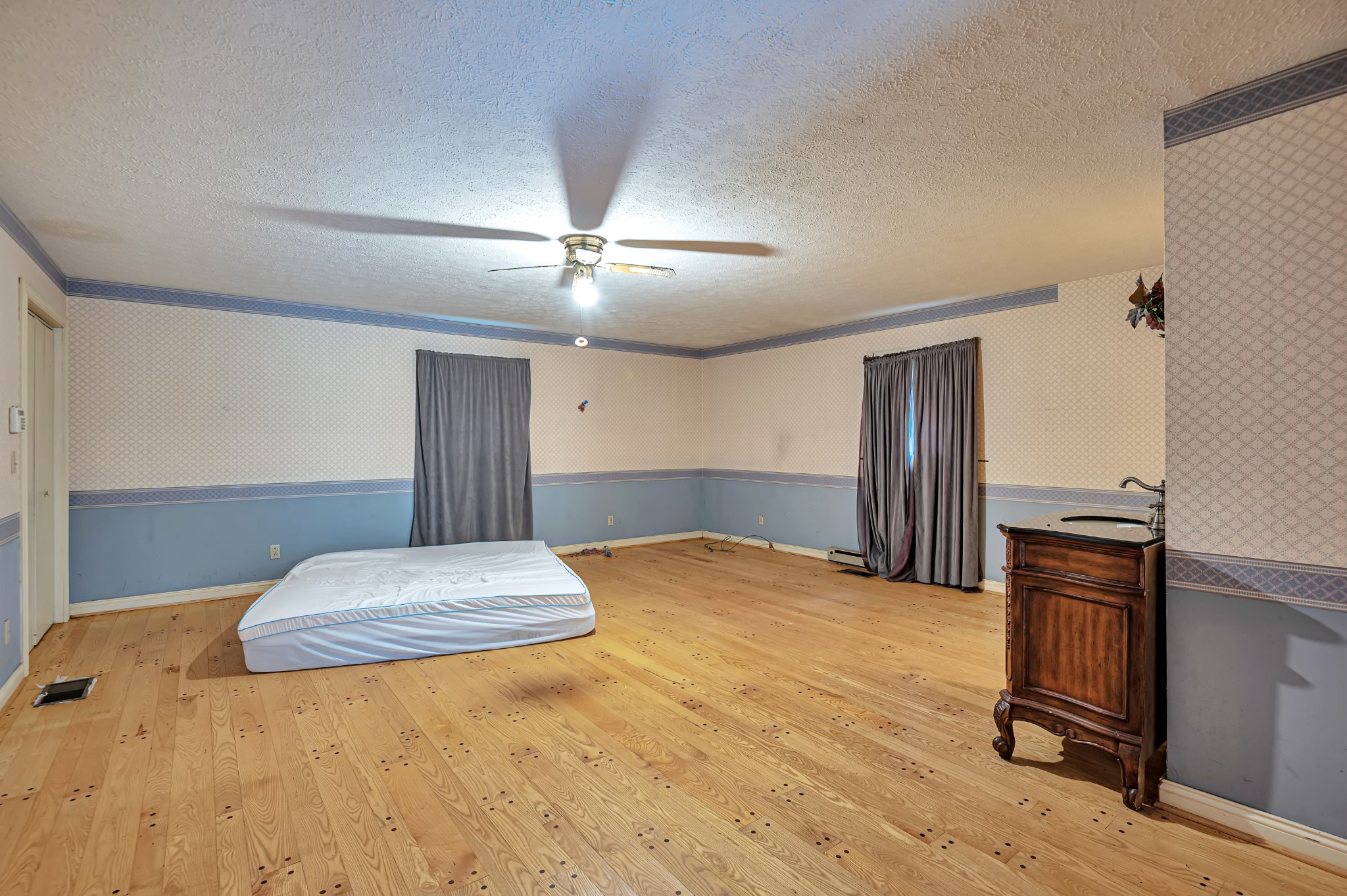 450 Womack Road Portland, TN 37148 - Photo 16 of 22 a bedroom with a bed and dresser with wooden floor