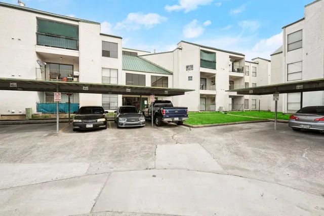 a car parked in front of a white building