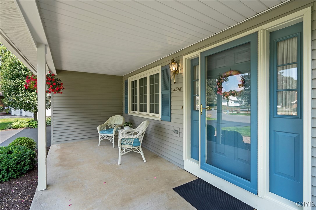4318 Cinnamon Path Clay, NY 13090 - Photo 3 of 50 The wide porch with room for seating and decorativ