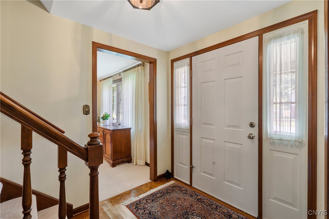4318 Cinnamon Path Clay, NY 13090 - Photo 4 of 50 And stepping inside, we see a bright foyer that le