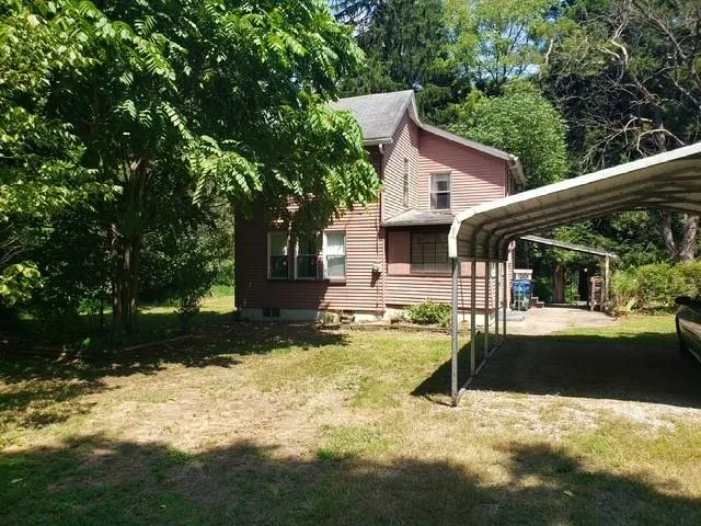 a view of a house with swimming pool and sitting area