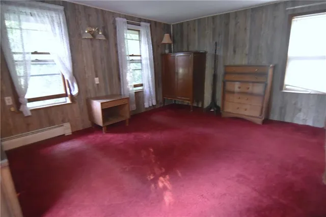 a view of empty room with a fireplace and windows