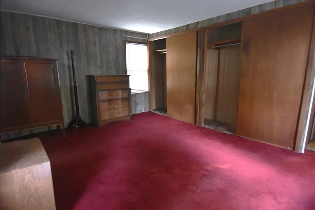 an empty room with windows and wooden door