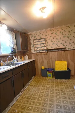 a kitchen with a sink cabinets and window