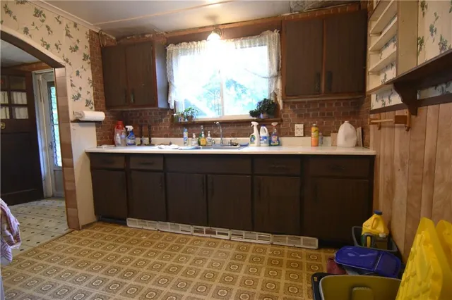 a kitchen with a sink cabinets and window