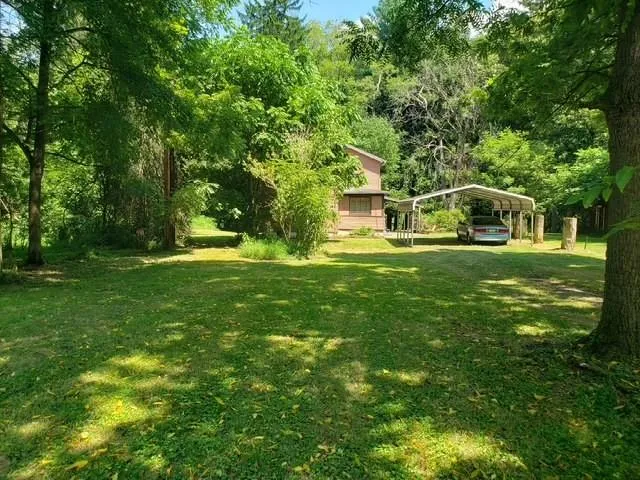 a backyard of a house with lots of green space
