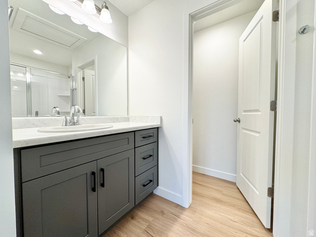 1650 North Main Street Layton, UT 84041 - Photo 18 of 24 Bathroom vanity featuring a light-colored countertop, an undermount sink, and a chrome faucet