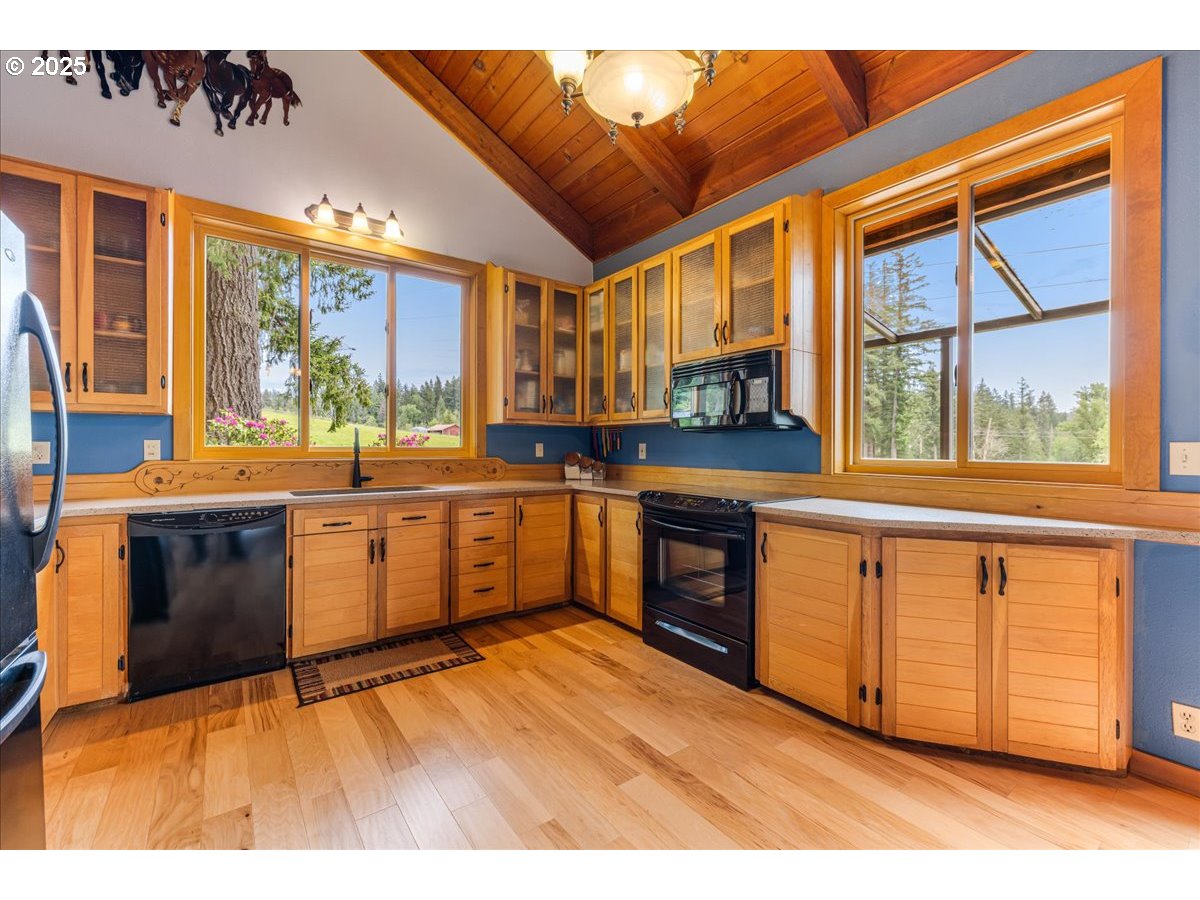 18258 South Dillman Road Oregon City, OR 97045 - Photo 13 of 43 a kitchen with stainless steel appliances granite countertop a stove a sink and a microwave