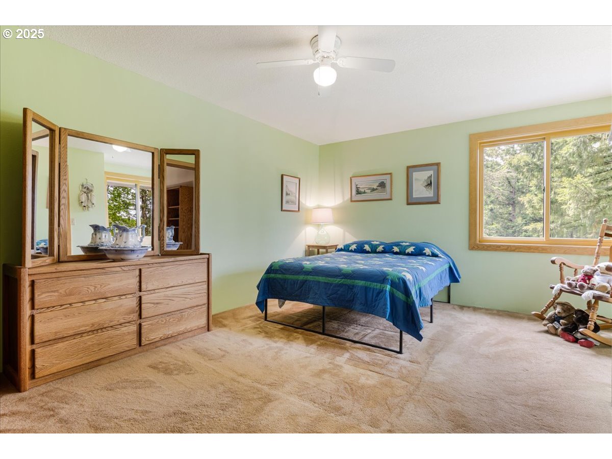 18258 South Dillman Road Oregon City, OR 97045 - Photo 24 of 43 a spacious bedroom with a bed and a window
