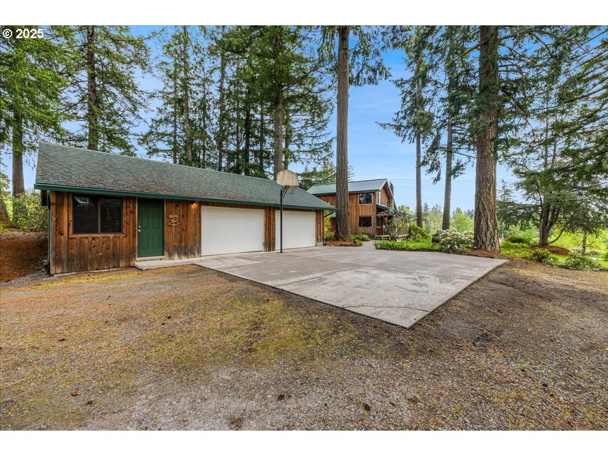 18258 South Dillman Road Oregon City, OR 97045 - Photo 4 of 43 a front view of a house with a yard and trees