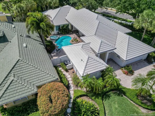 an aerial view of a house with garden space and sitting area