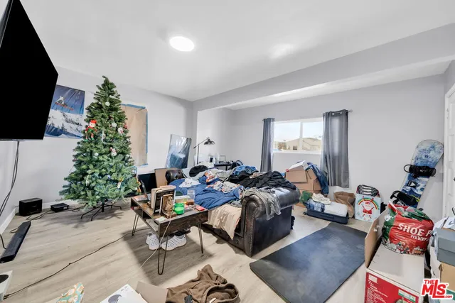 a bedroom with furniture and a flat screen tv