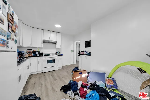 a bedroom with bed and wooden floor