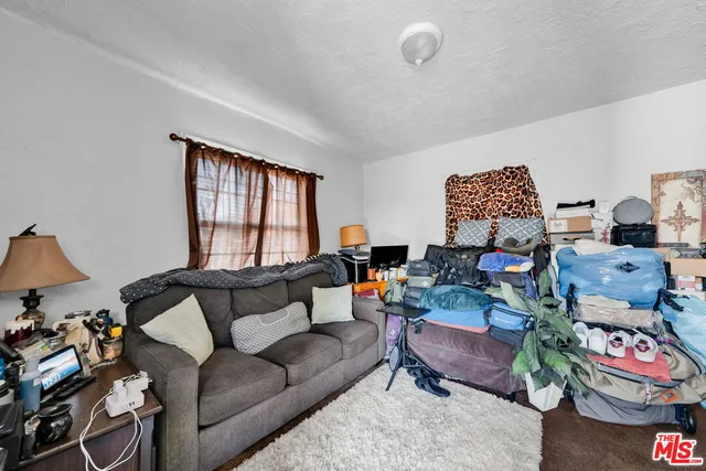 a bedroom with bed and a chandelier