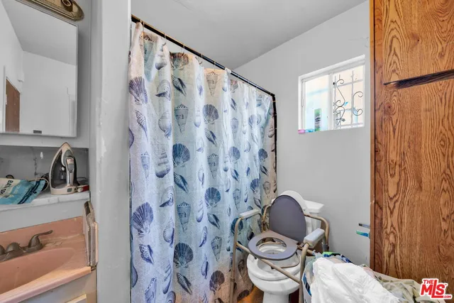 a kitchen with granite countertop a refrigerator stove top oven and sink