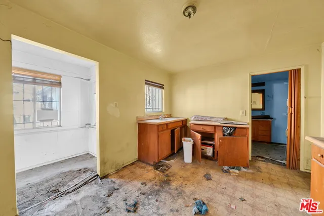 an aerial view of a house with swimming pool and outdoor seating