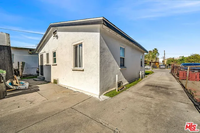 a bed room with a bed a television and a couch