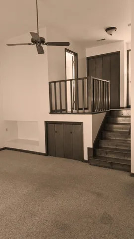 a view of staircase with white walls and a window