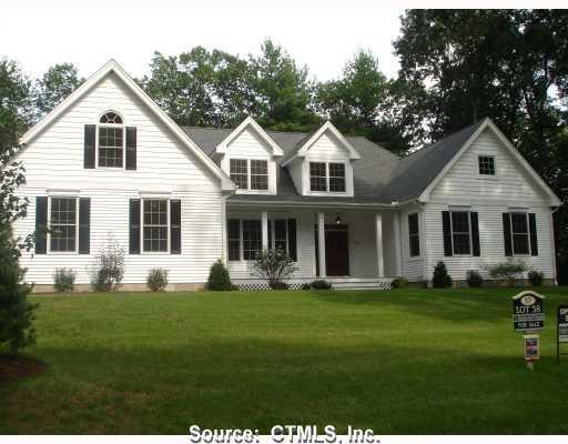 Exterior Front. View of the front of the home featuring a covered front porch, professional landscaping, and vinyl siding.