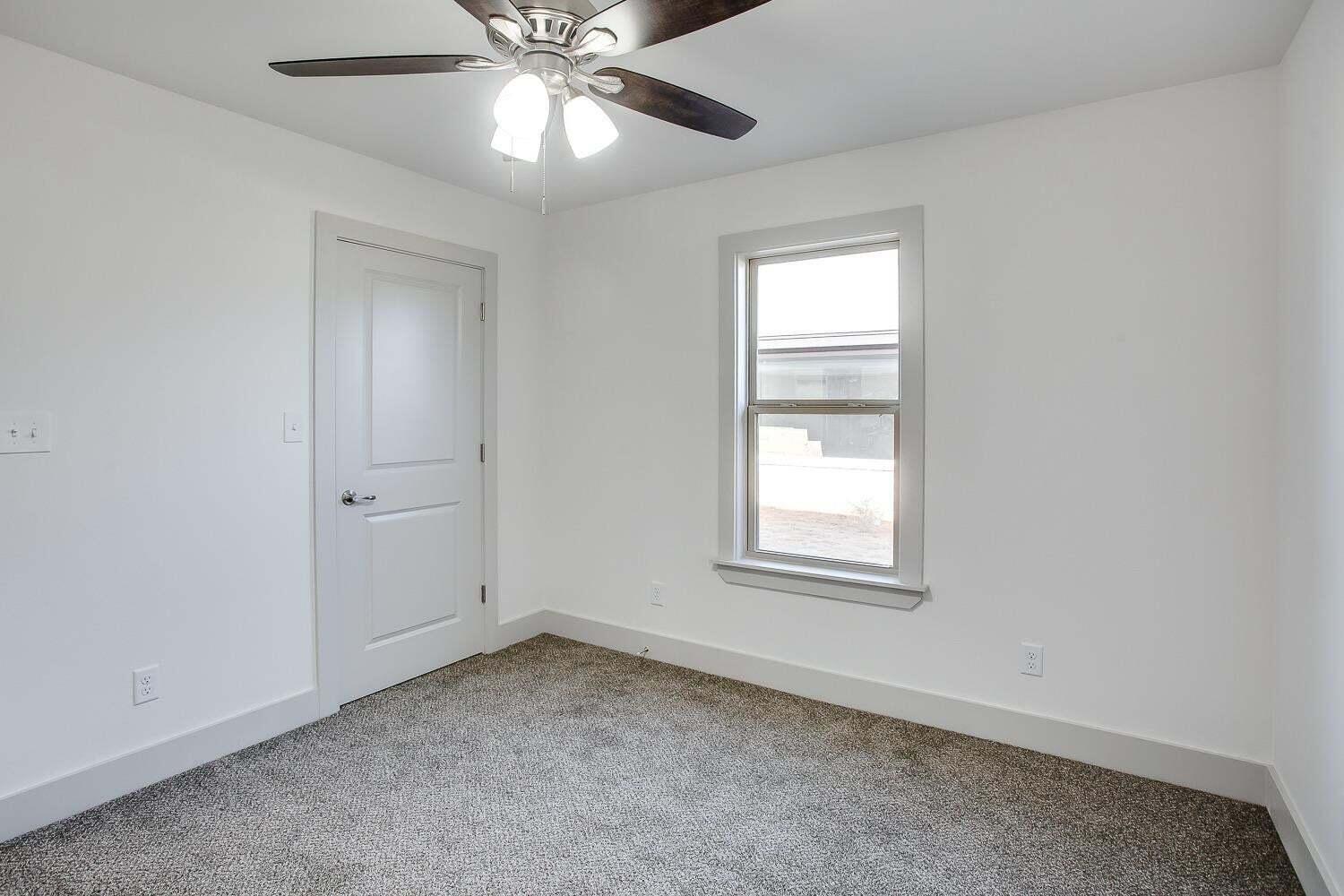 811 North 4th Street Wolfforth, TX 79382 - Photo 14 of 18 an empty room with a window and a fan