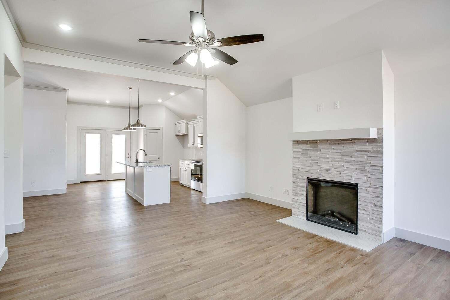 811 North 4th Street Wolfforth, TX 79382 - Photo 2 of 18 a view of an empty room with wooden floor fireplace and a window