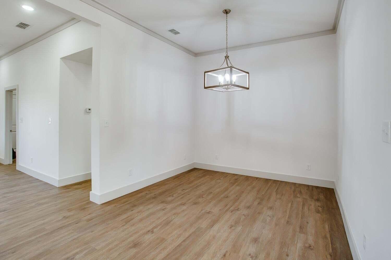 811 North 4th Street Wolfforth, TX 79382 - Photo 9 of 18 a view of empty room with wooden floor