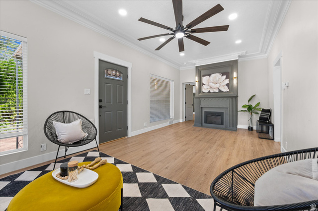 327 35th Street Ogden, UT 84401 - Photo 8 of 31 Spacious living area featuring wood-finish flooring, a contemporary ceiling fan with integrated lighting, and crown molding