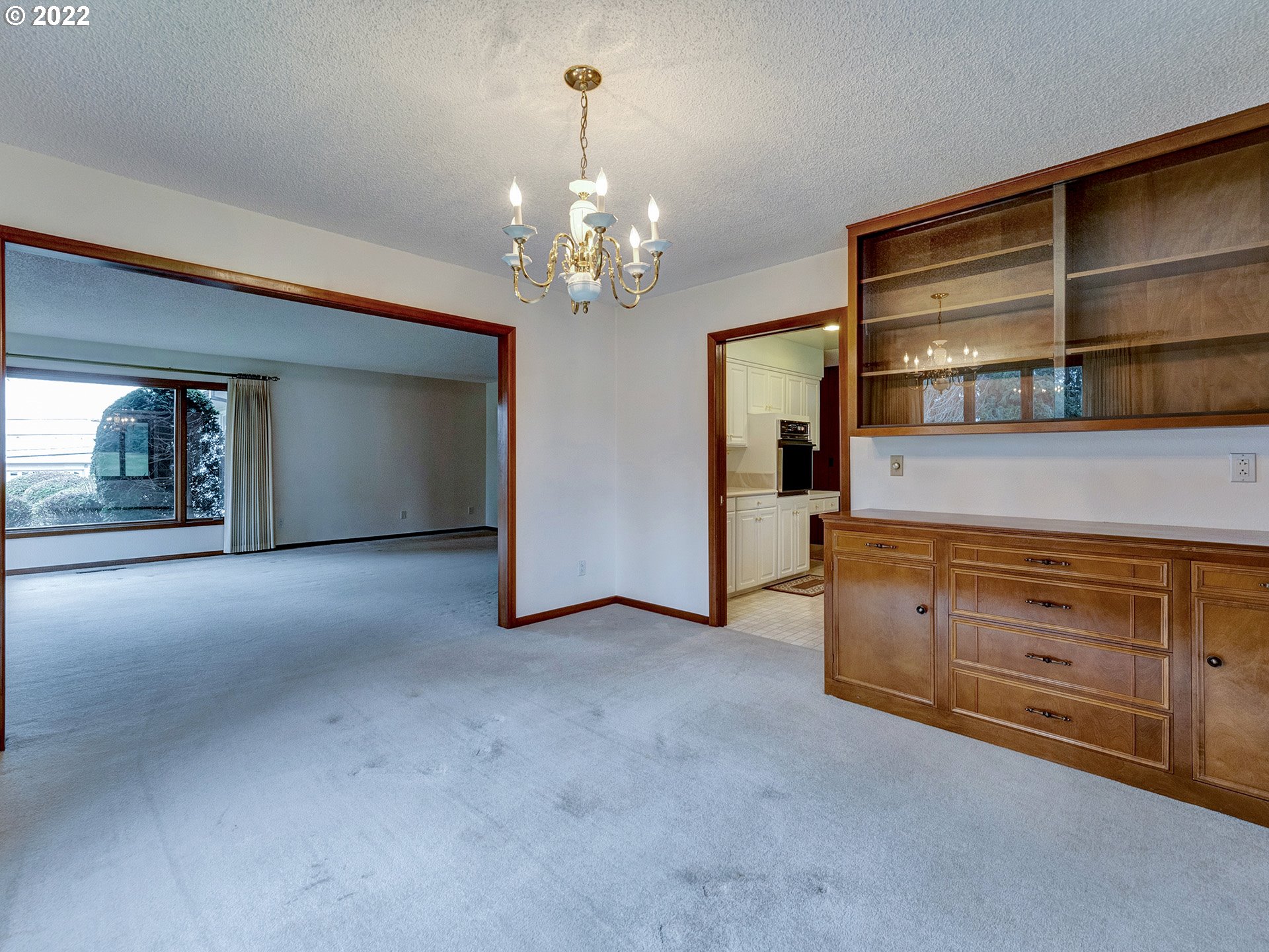 27651 Southeast Kelso Road Boring, OR 97009 - Photo 12 of 32 a view of an empty room with cabinet and chandelier