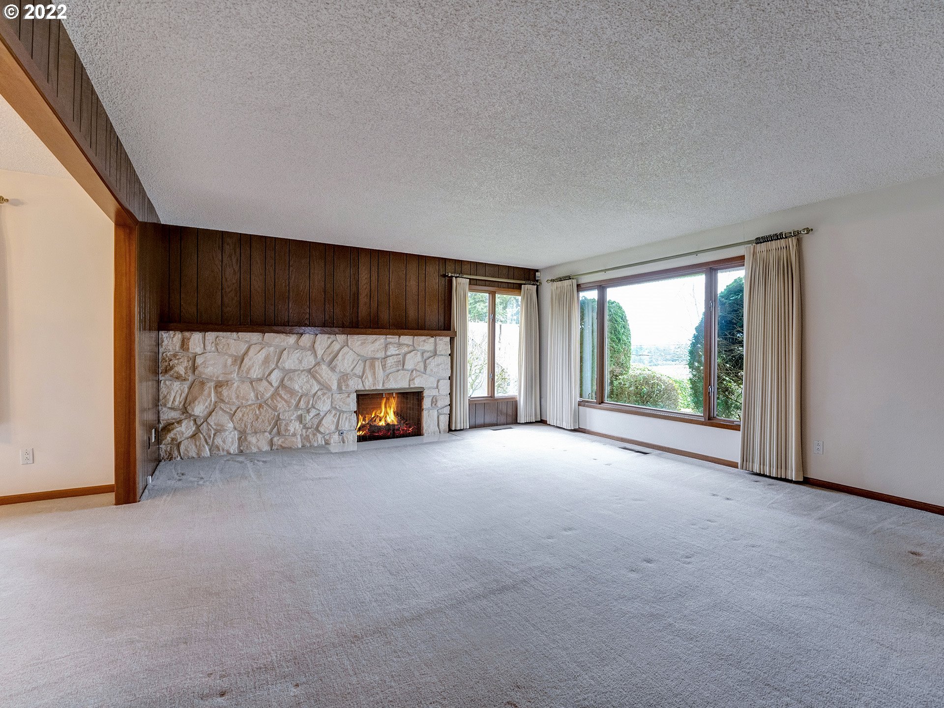27651 Southeast Kelso Road Boring, OR 97009 - Photo 13 of 32 a view of an empty room with a fireplace and a window