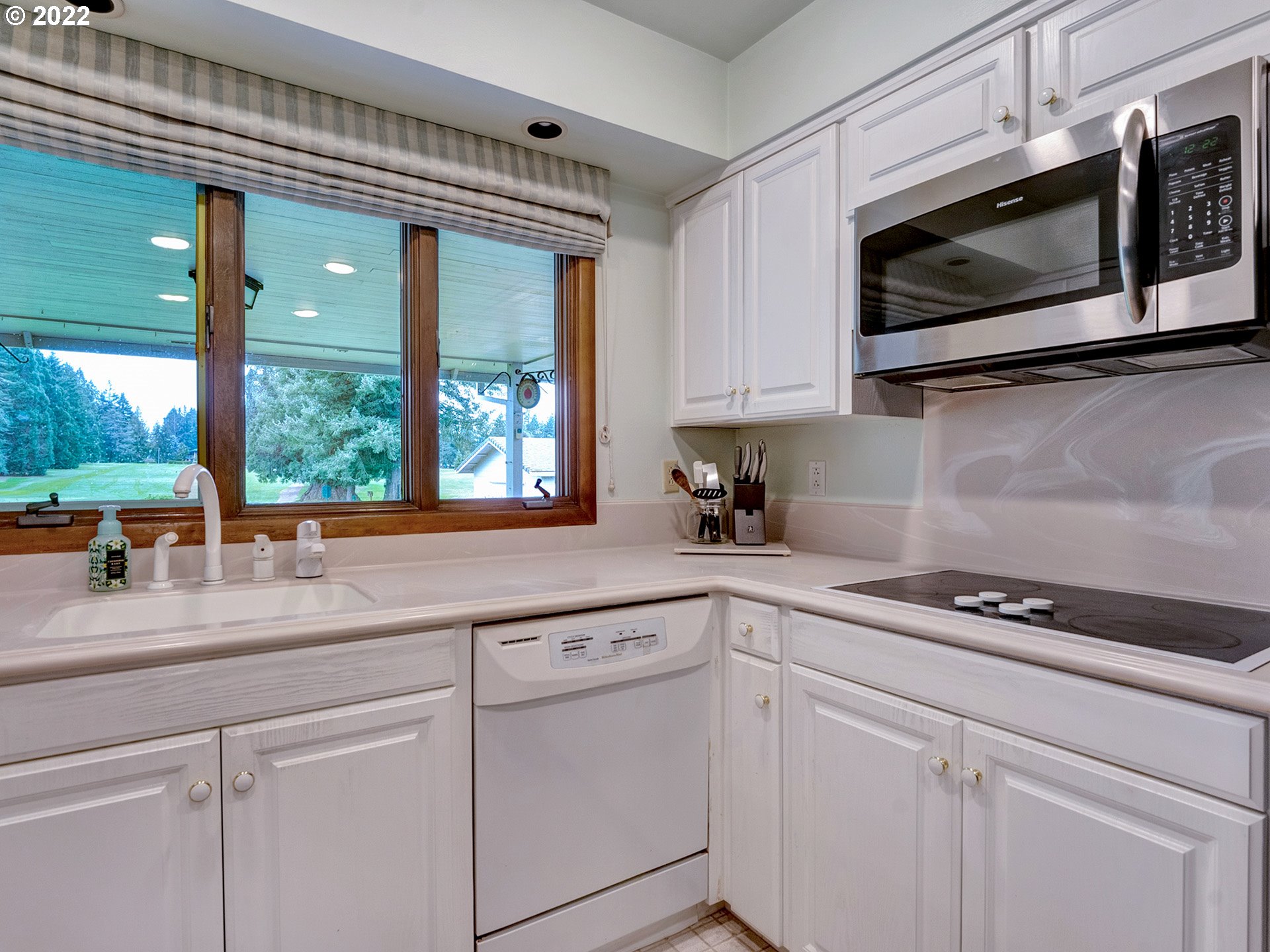 27651 Southeast Kelso Road Boring, OR 97009 - Photo 5 of 32 a kitchen with stainless steel appliances white cabinets and a stove top oven