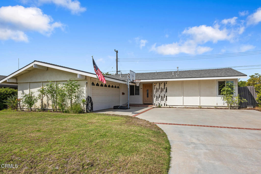 a view of a house with a yard and garage