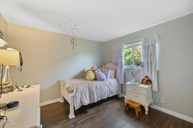 a bedroom with furniture and a wooden floor
