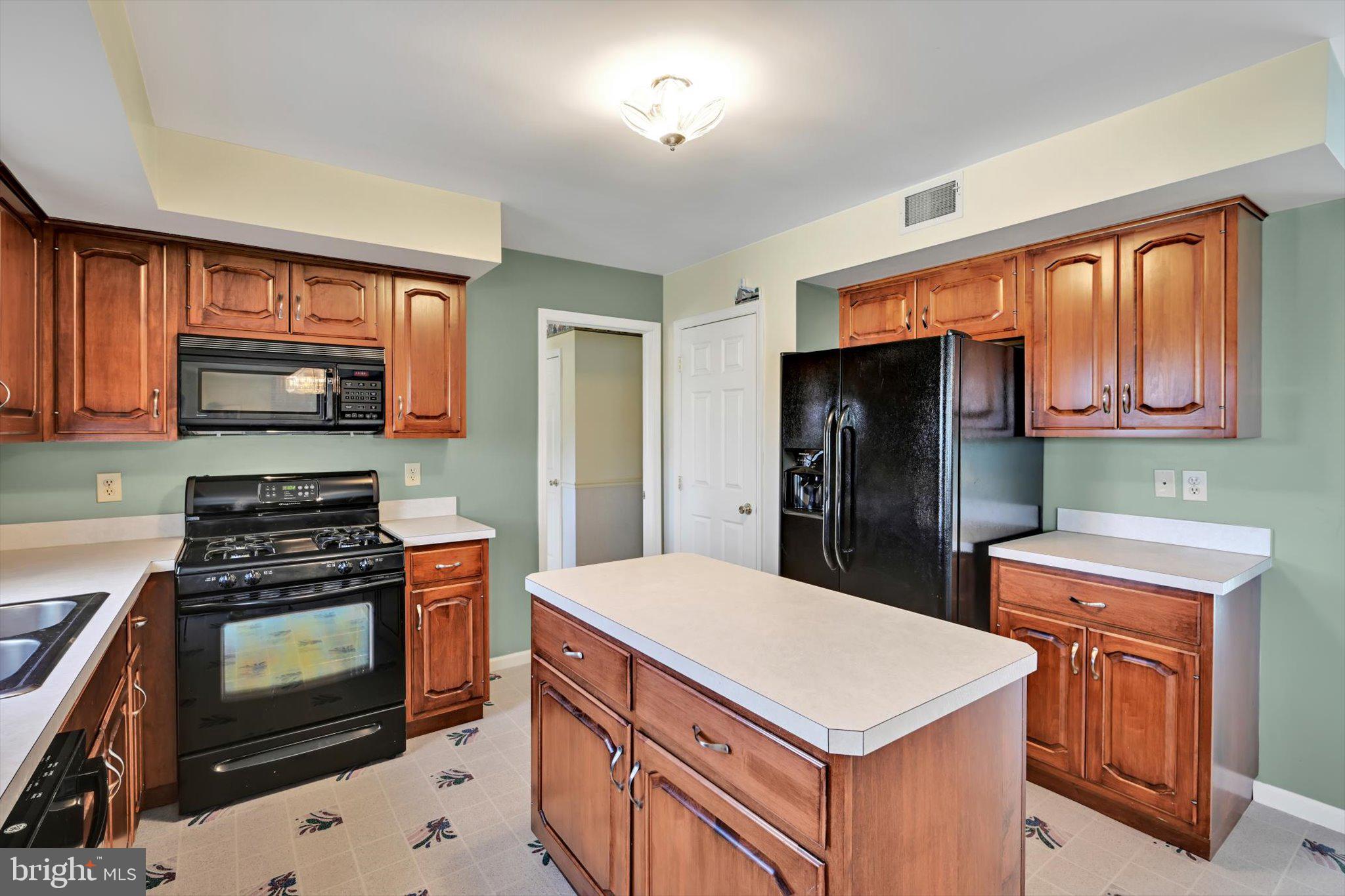 2701 Huyett Drive Sinking Spring, PA 19608 - Photo 17 of 35 a kitchen with a stove a sink and a refrigerator