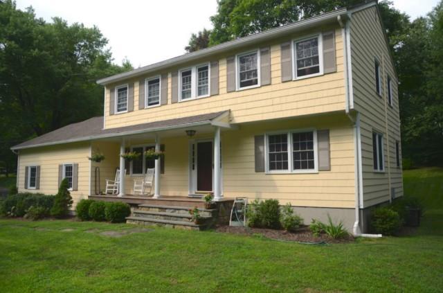 116 Deer Run Road Wilton, CT 06897 - Photo 1 of 1 a front view of a house with a garden and yard