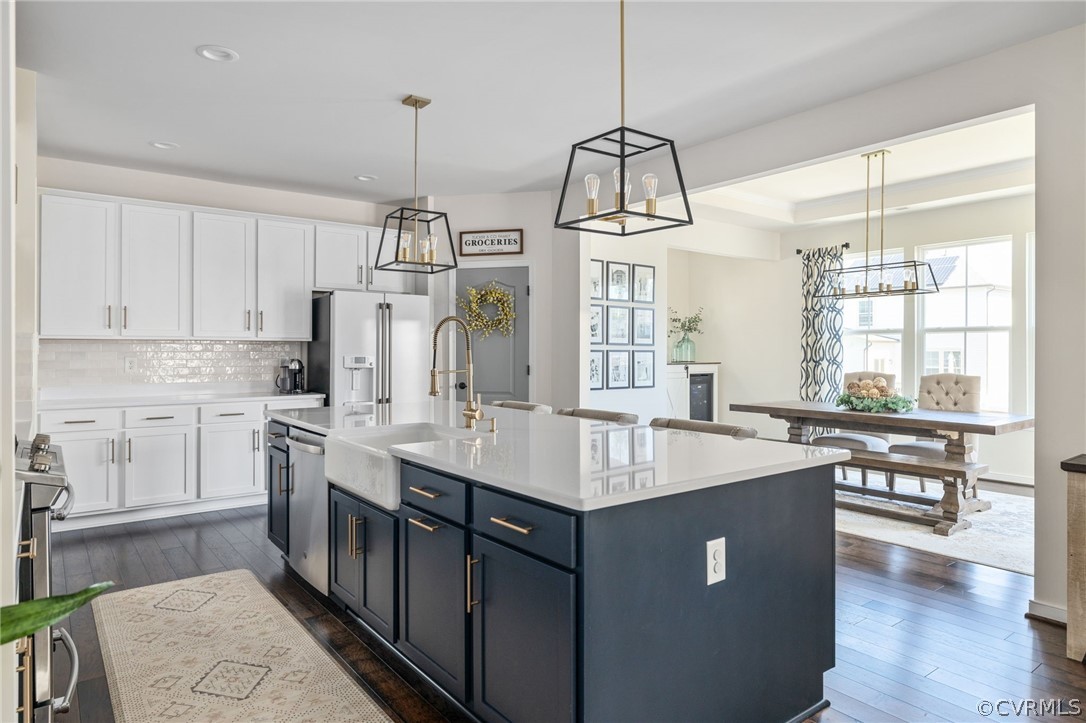 10946 Pointer Holly Path Glen Allen, VA 23059 - Photo 15 of 48 a kitchen with kitchen island granite countertop a sink a counter space appliances and cabinets