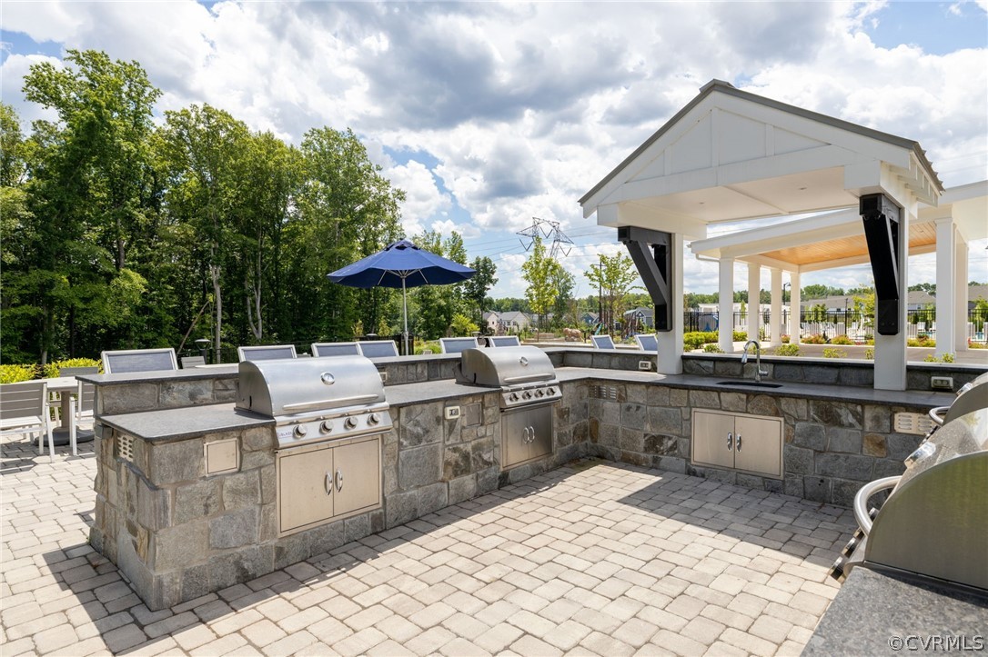 10946 Pointer Holly Path Glen Allen, VA 23059 - Photo 44 of 48 a table and chairs sitting in a backyard with a barbeque