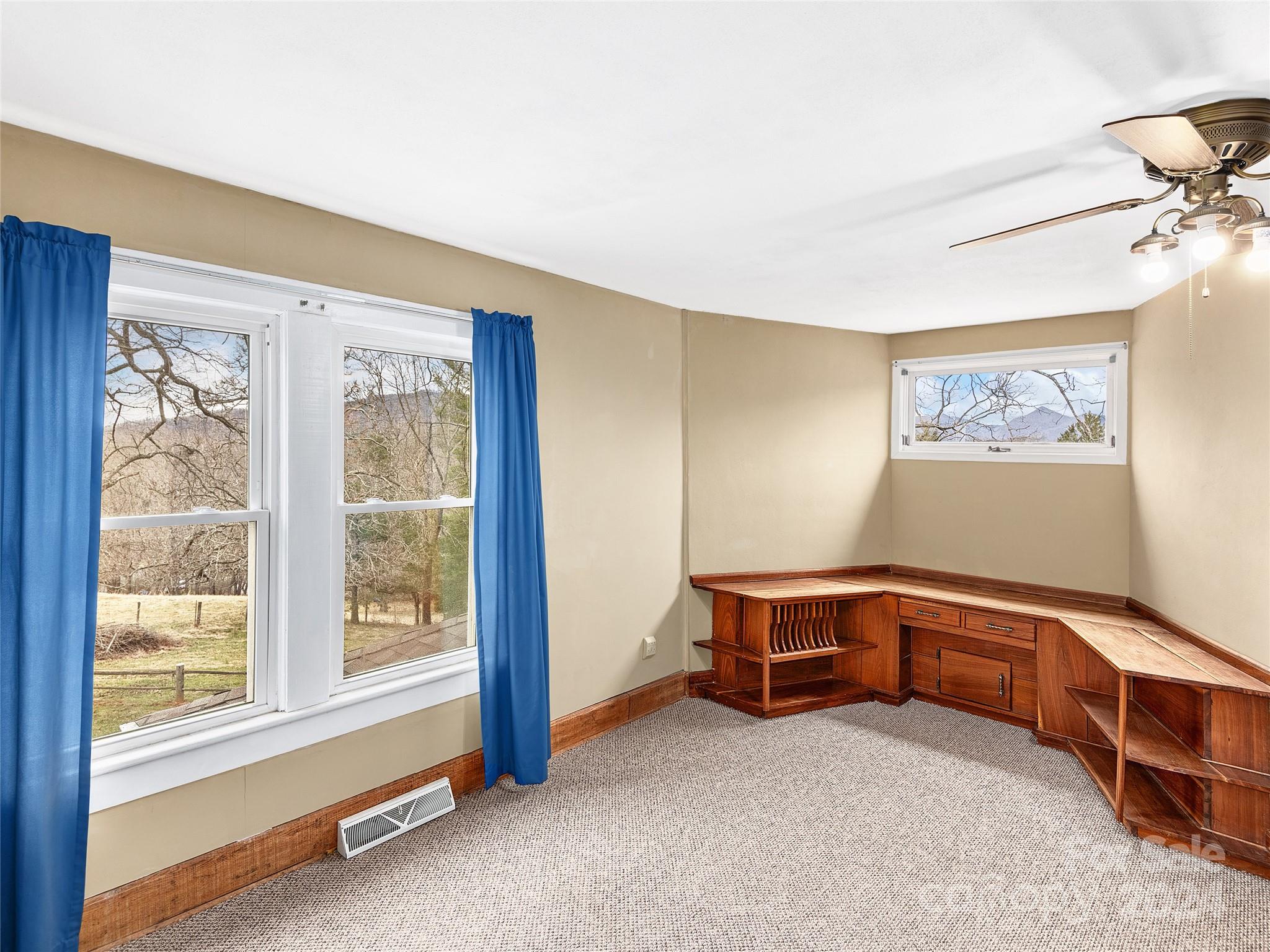 704 Mulberry Street Clyde, NC 28721 - Photo 17 of 36 a view of a bedroom with furniture and a window