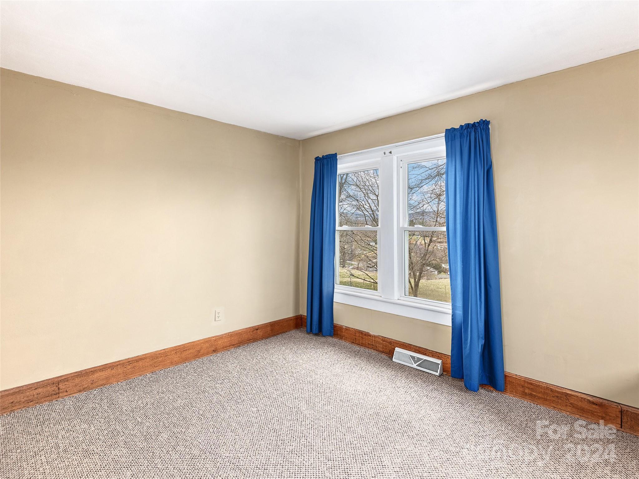 704 Mulberry Street Clyde, NC 28721 - Photo 18 of 36 an empty room with windows