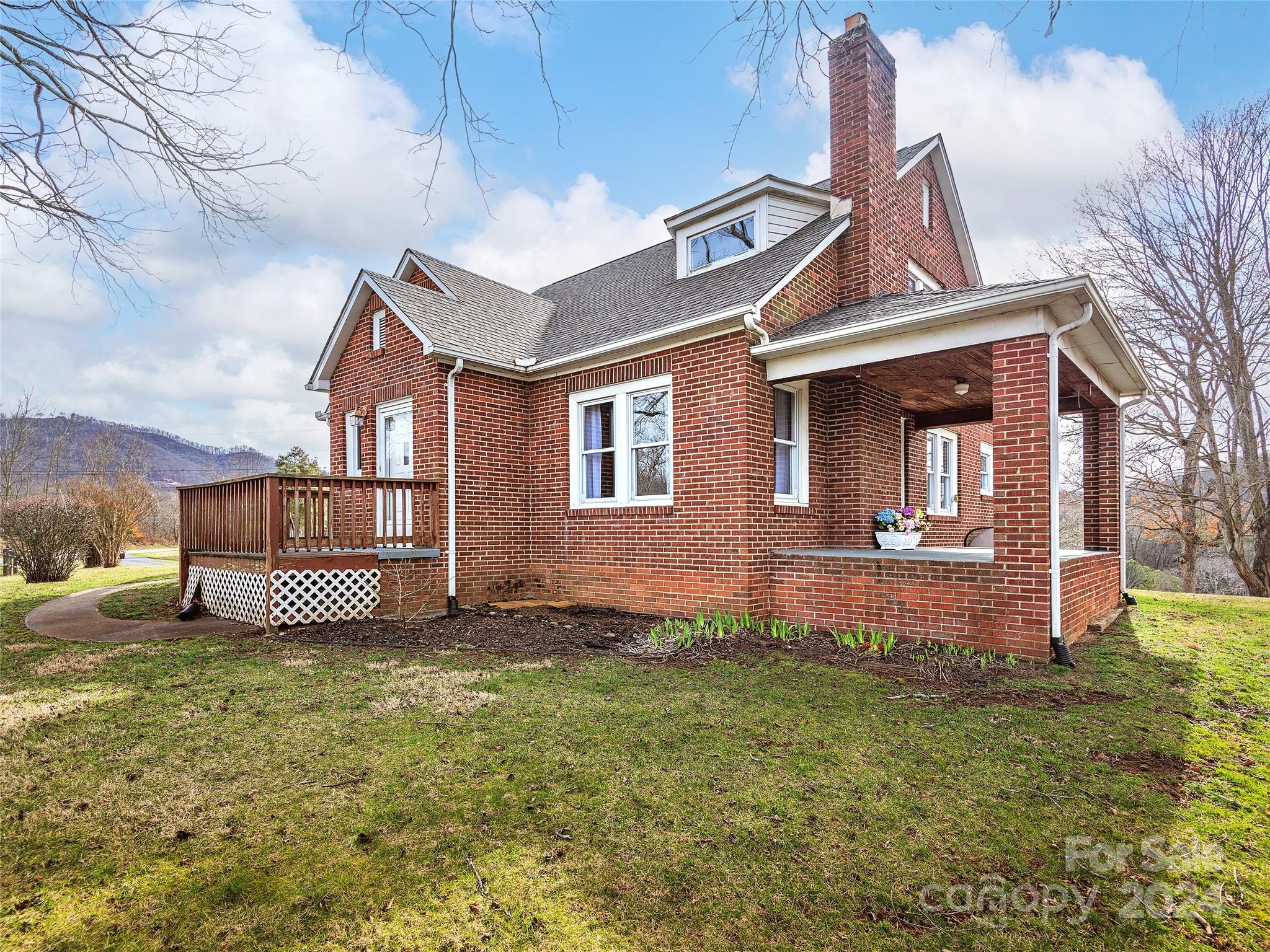 704 Mulberry Street Clyde, NC 28721 - Photo 24 of 36 a front view of a house with garden
