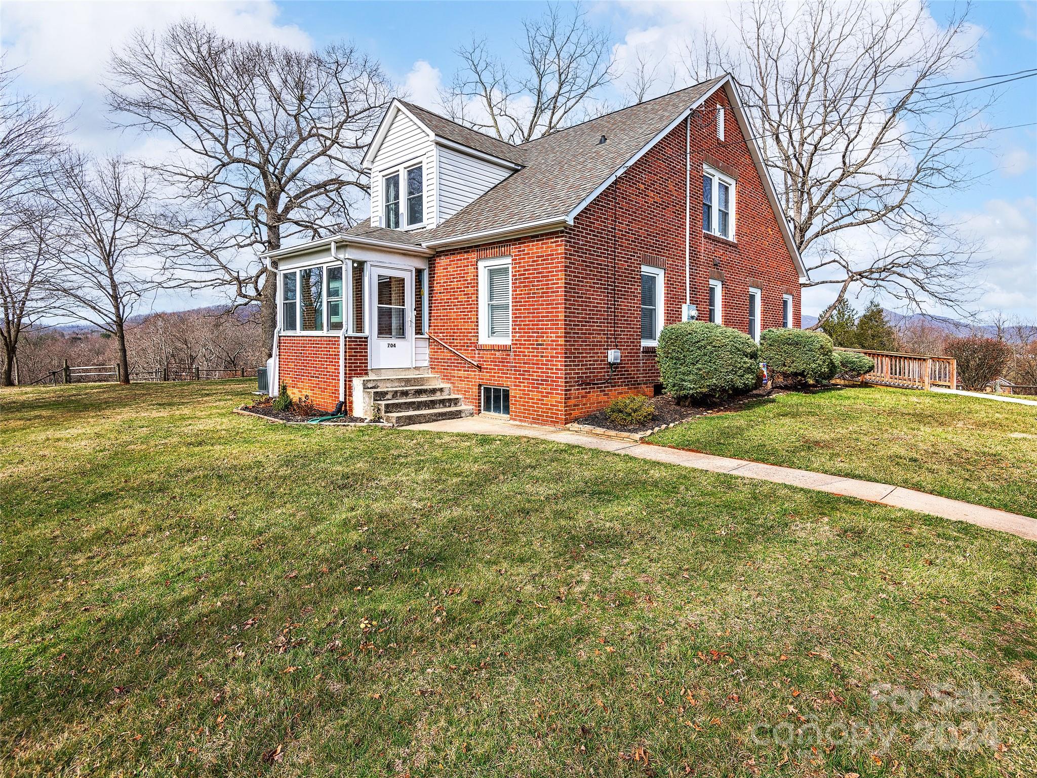 704 Mulberry Street Clyde, NC 28721 - Photo 25 of 36 a view of a house with a big yard and large trees